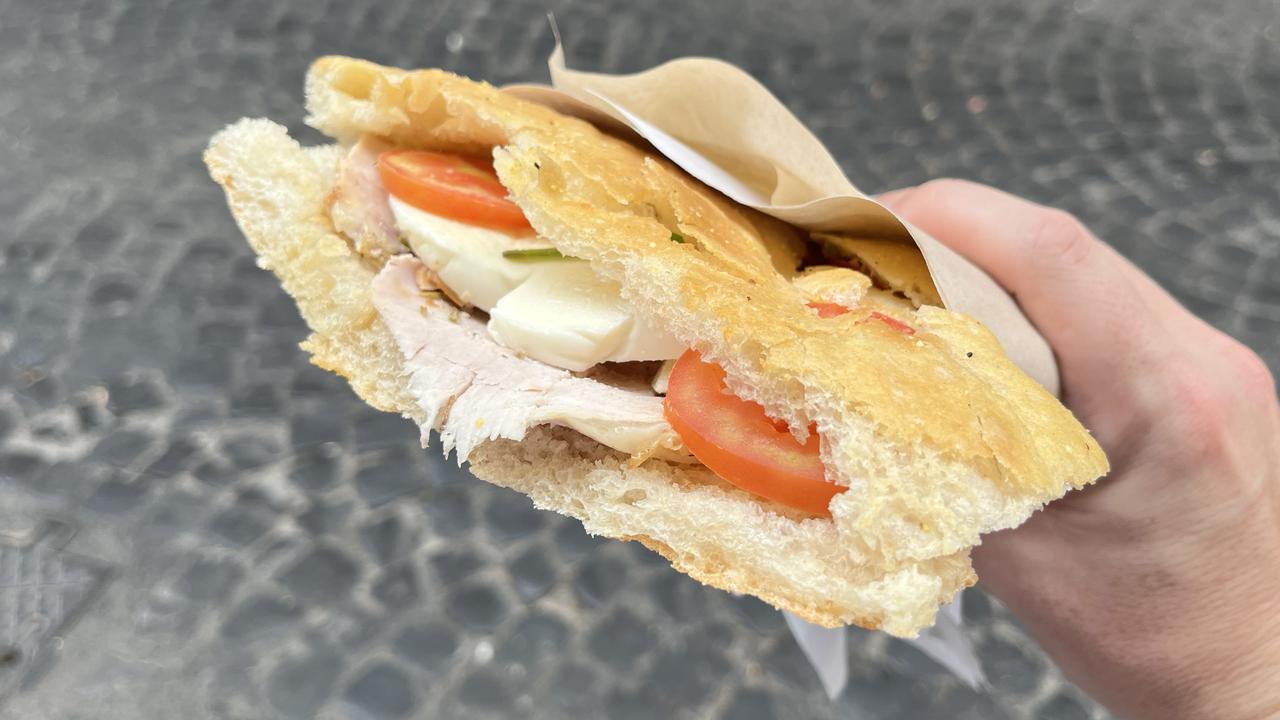 A panini with roast pork, tomato, basil and mozzarella.