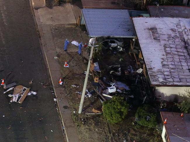 Queensland forensic investigators inspect the scene. Pictures: Jack Tran / The Courier Mail