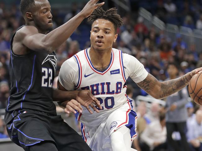 Philadelphia 76ers' Markelle Fultz (20) drives around Orlando Magic's Jerian Grant (22) during the first half of an NBA basketball game Wednesday, Nov. 14, 2018, in Orlando, Fla. (AP Photo/John Raoux)