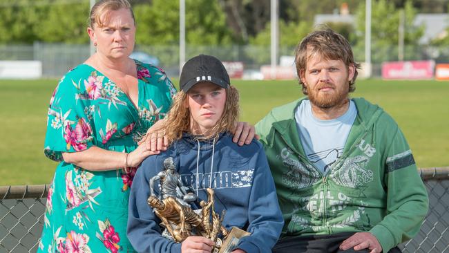 Caleb Keen, 14, with his parents Kylie and Aaron after he was attacked during a junior football match game. Picture: Jason Edwards