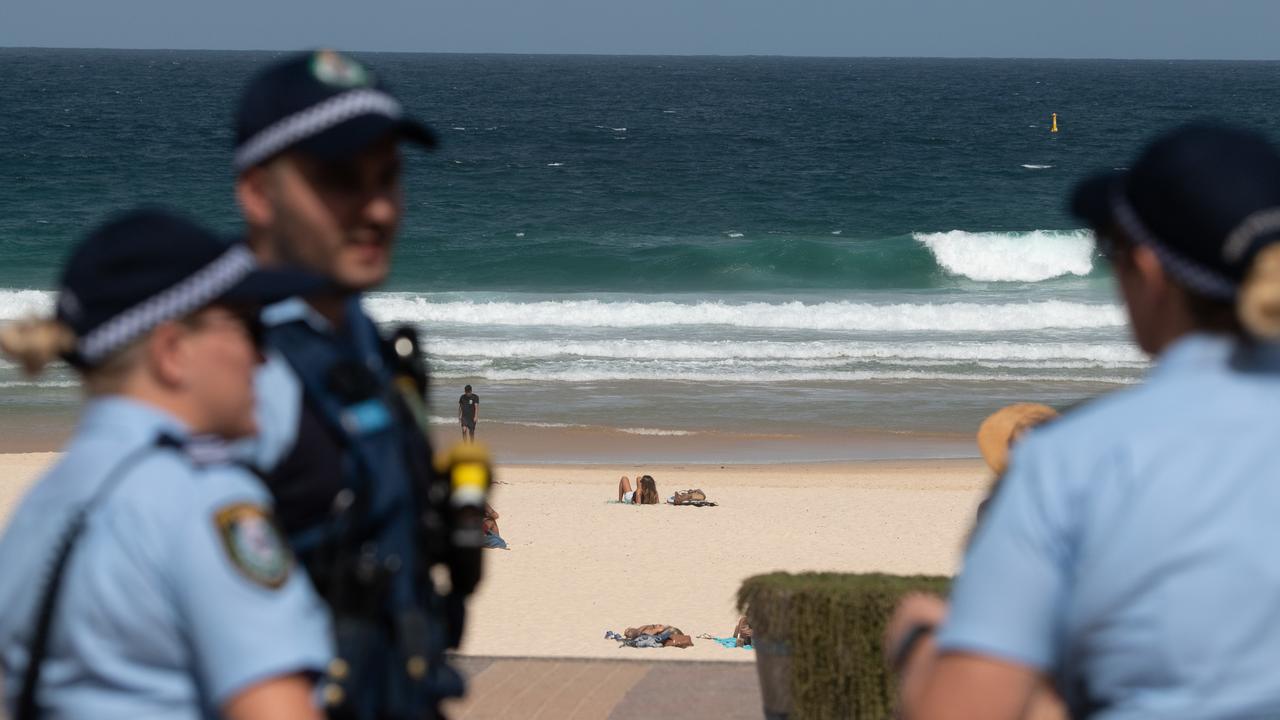 Police officers patrol Bondi Beach prior to its closure in Sydney on Saturday. Picture: AP Image/James Gourley)