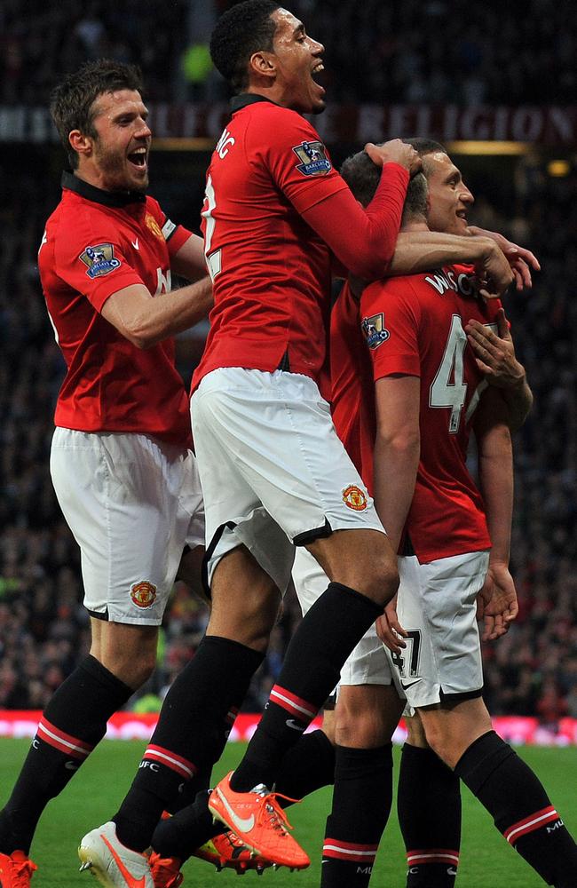 Manchester United players celebrate James Wilson’s opening goal.