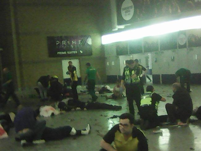 Helpers attend to people inside the Manchester Arena after a bomb exploded in the foyer. Picture: PA Wire