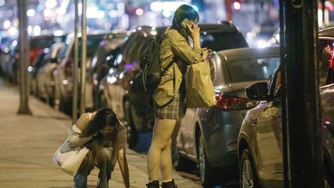 A woman tries to call a cab with her friend. Picture: David Geraghty