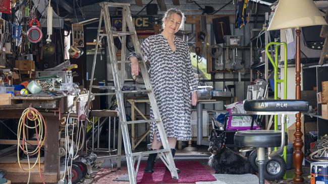 Rosalie Ham with dog Harrie inside Ian’s shed at their home in Brunswick. Picture: Sean Davey