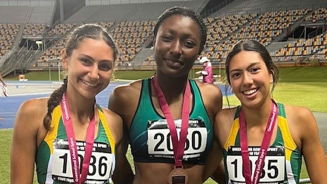 Zara Hagan of St Aidan's AGS, Ebony Okonkwo of St Margaret's AGS and Rhani Hagan of St Aidan's AGS following the 100m sprints.