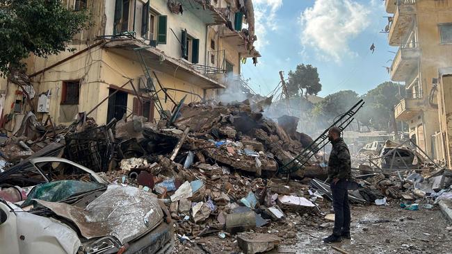 A man checks the destruction at the site of an Israeli airstrike targeting a neighborhood in southern Beirut on November 13, 2024, amid the ongoing war between Israel and Hezbollah. (Photo by Anwar AMRO / AFP)