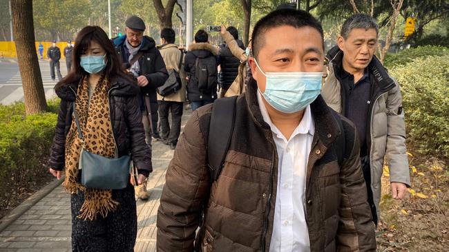 Lawyer Ren Quanniu, centre, representing Chinese citizen journalist Zhang Zhan, arrives at the Shanghai Pudong New District People's Court on Monday. Picture: AFP