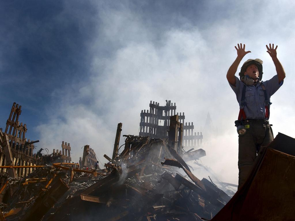 A New York City fireman calls for 10 more rescue workers to make their way into the rubble of the World Trade Centre. Picture: Alamy