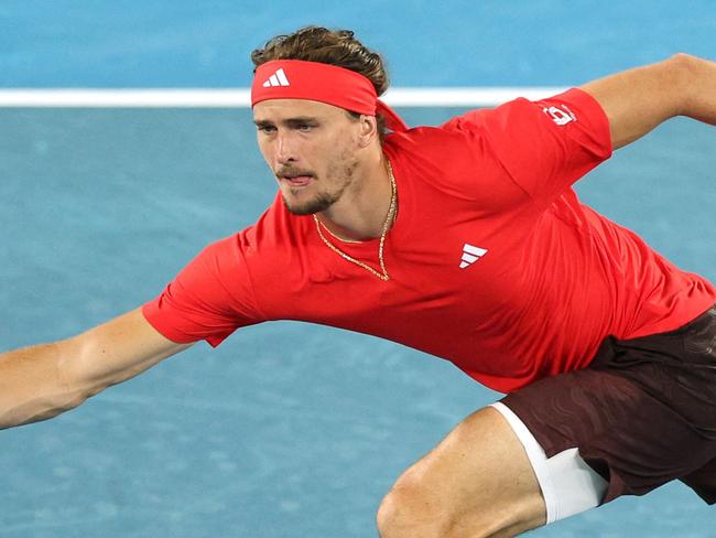 TOPSHOT - Germany's Alexander Zverev hits a shot against France's Lucas Pouille during their men's singles match on day one of the Australian Open tennis tournament in Melbourne on January 12, 2025. (Photo by Adrian Dennis / AFP) / -- IMAGE RESTRICTED TO EDITORIAL USE - STRICTLY NO COMMERCIAL USE --