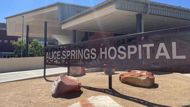 A worker is recovering in Alice Springs Hospital after he was allegedly stabbed in stomach of the Woolworths loading dock