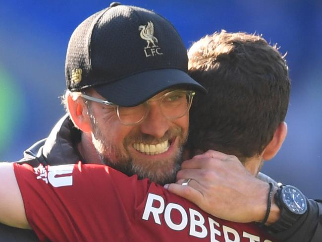 CARDIFF, WALES - APRIL 21:  Jurgen Klopp, Manager of Liverpool celebrates victory with Andy Robertson after the Premier League match between Cardiff City and Liverpool FC at Cardiff City Stadium on April 21, 2019 in Cardiff, United Kingdom. (Photo by Mike Hewitt/Getty Images)