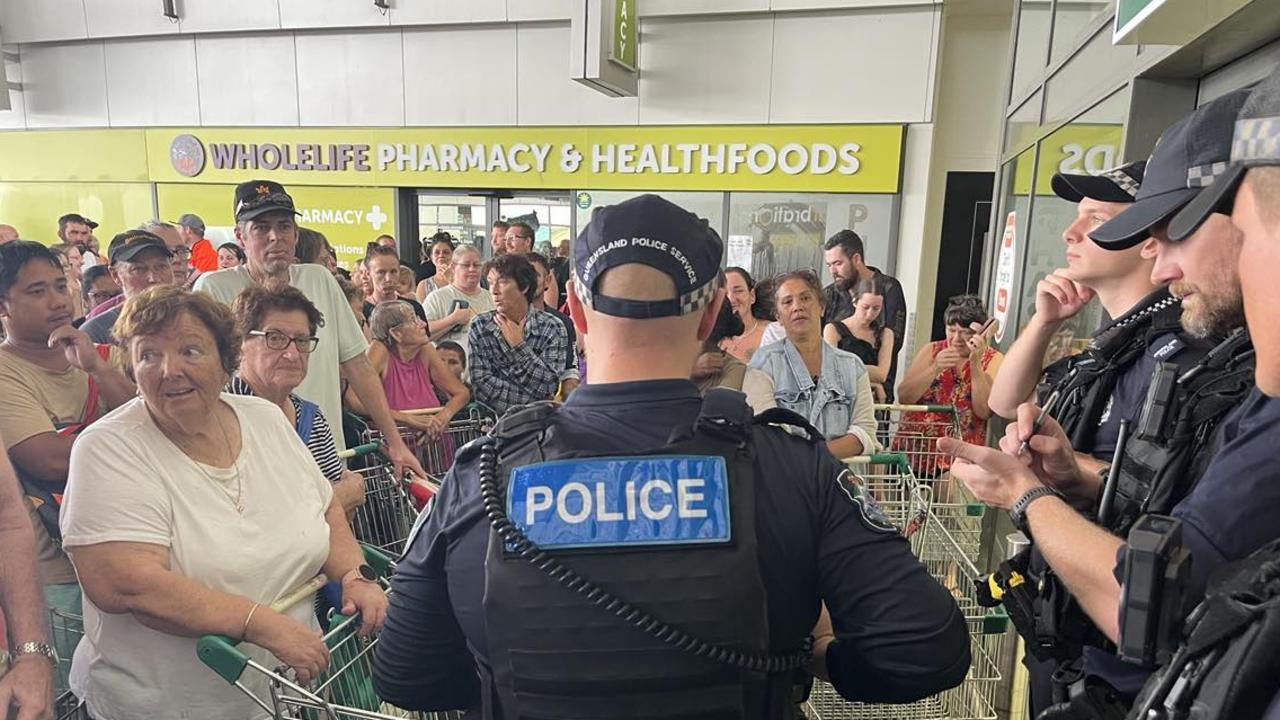 More than 200 Ingham residents await for Woolworths to open with police letting 20 customers through at a time. Picture: Cameron Bates