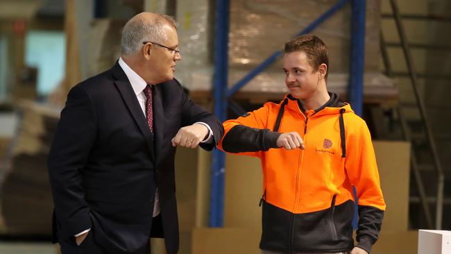 Prime Minister Scott Morrison bumps elbows with a DisplayWise employee during a visit to the DisplayWise workshop in Miranda. Picture: Getty Images