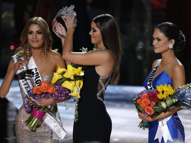 Former Miss Universe Paulina Vega, center, removes the crown from Miss Colombia Ariadna Gutierrez, left, before giving it to Miss Philippines Pia Alonzo Wurtzbach. AP Photo/John Locher.