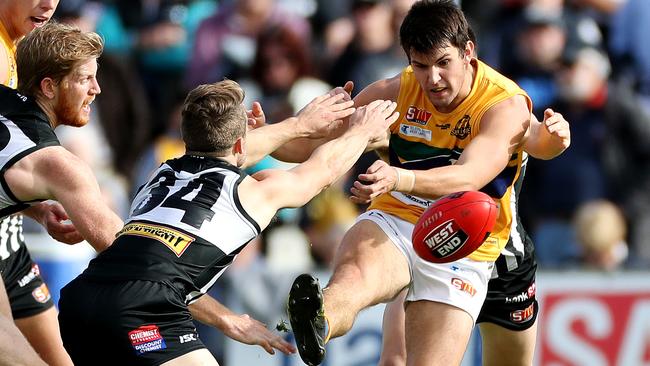 Woodville West Torrens’ Sam Rowland kicks away from Port Adelaide’s Will Snelling.