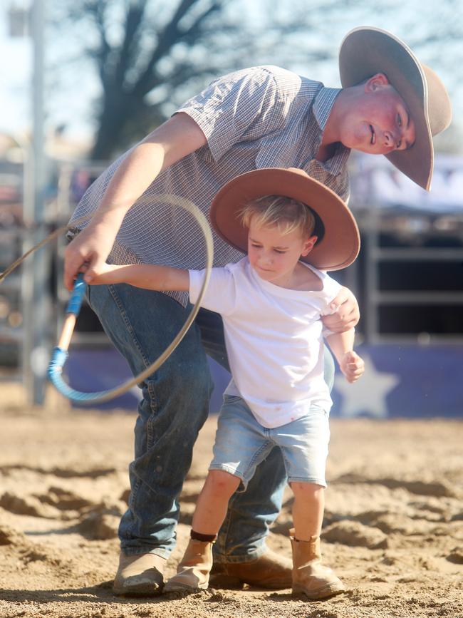 Riley Hilton, from Lurg, teaches whipcracking to Zayde Pearson, 5, from Langwarrin. Picture: Yuri Kouzmin