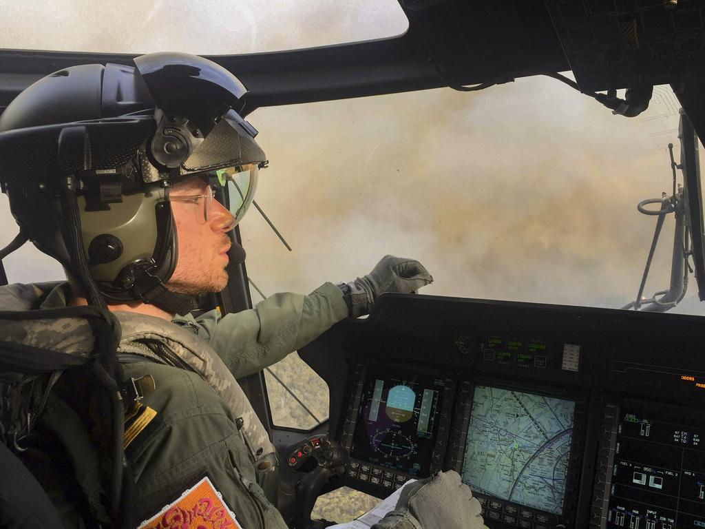 Royal Australian Navy Pilot Lieutenant Commander Nick Grimmer, RN, in an 808 Squadron MRH90 Taipan Military Support Helicopter over the Grose Valley bushfire in the Blue Mountains National Park. Picture: ADF