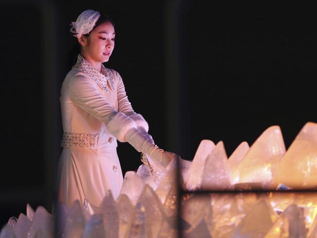 South Korean Olympic figure skating champion Yuna Kim lights the Olympic cauldron. Picture: AP