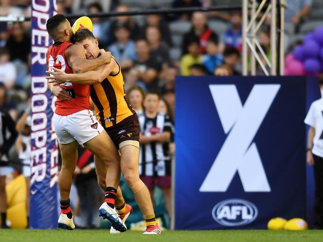 Anthony McDonald-Tipungwuti of the Bombers is tackled by Dallas Willsmore of the Hawks during the Pool B match between the Essendon Bombers and the Hawthorn Hawks during the AFLX Melbourne tournament at Etihad Stadium in Melbourne, Friday, February 16, 2018. (AAP Image/Tracey Nearmy) NO ARCHIVING, EDITORIAL USE ONLY