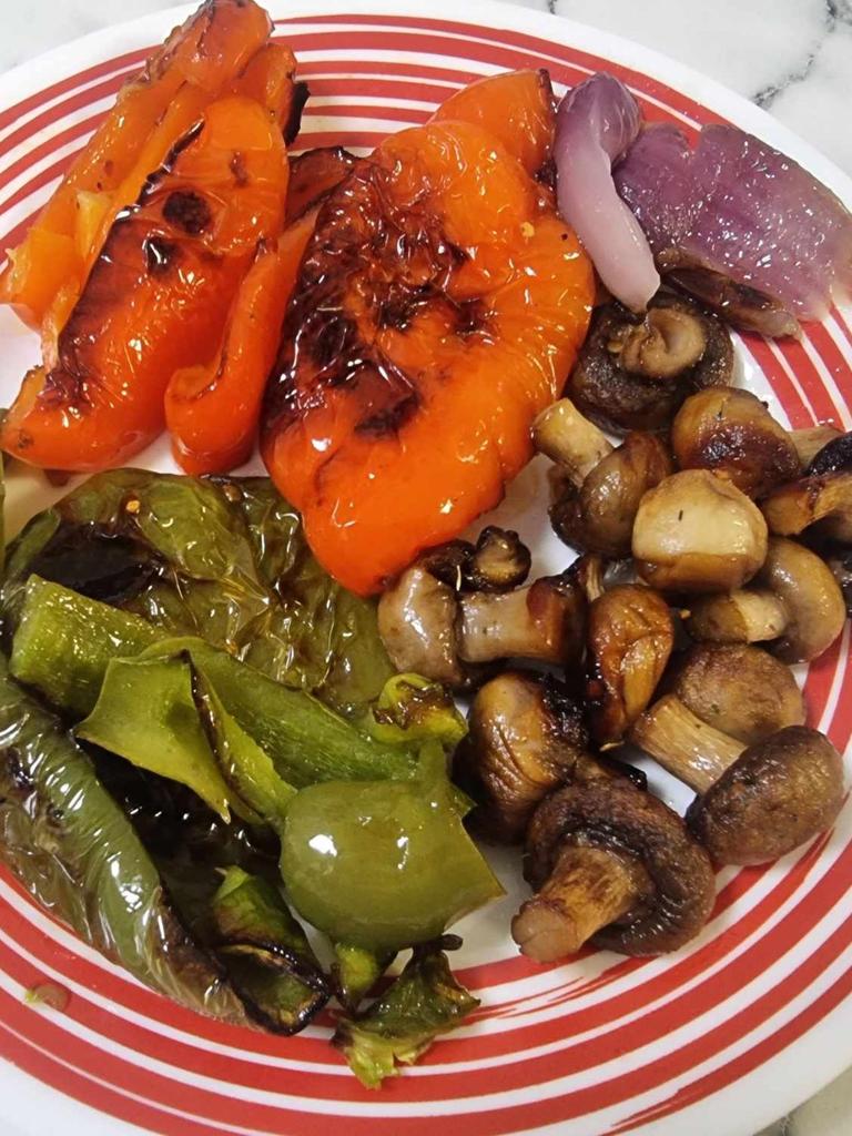 Cooking mushrooms, capsicum and onions in the pizza oven. Picture: Tahnee-Jae Lopez-Vito/news.com.au.