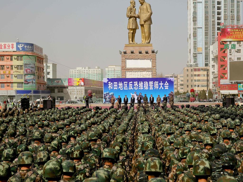 Chinese military police attending an anti-terrorist oath-taking rally in Hotan, in northwest China's Xinjiang Uighur Autonomous Region. Picture: STR / AFP