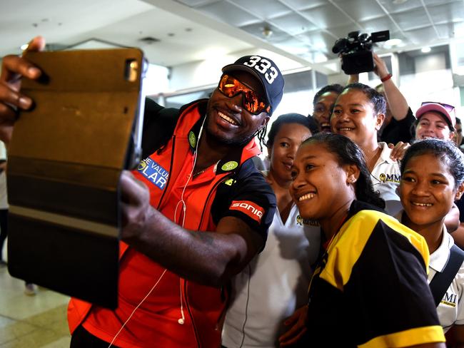 Chris Gayle poses for photographs with the PNG Womens Cricket Team