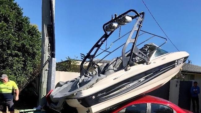 A boat has landed on top of a car during a dramatic crash at Palm Beach on the Gold Coast. Photo: Queensland Ambulance