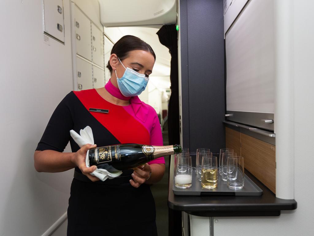 Ms Nash practising her pouring skills ahead of the November 1 restart. Picture: Qantas