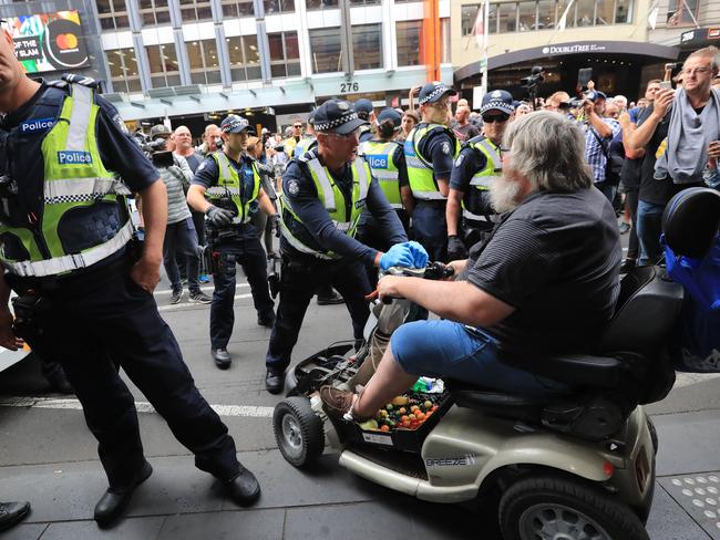 A man on a mobility scooter was seen driving into police. Picture: Alex Coppel.