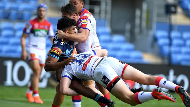 GOLD COAST, AUSTRALIA - APRIL 21: Tyrone Peachey of the Titans is tackled during the round 6 NRL match between the Titans and the Knights at Cbus Super Stadium on April 21, 2019 in Gold Coast, Australia. (Photo by Bradley Kanaris/Getty Images)