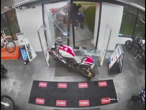 CCTV at Gladstone Motorcycles has shown the moment two people broke in and stole two motorbikes