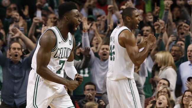 The Boston Celtics celebrate beating the Toronto Raptors for their 12th straight win. (AP Photo/Winslow Townson)