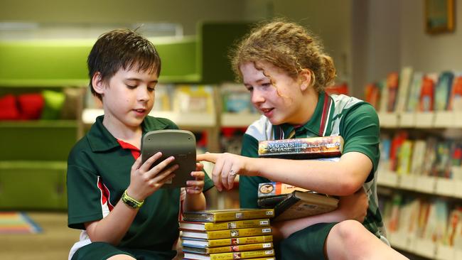 Saxon See Kee, 10, and Lucy Seaton, 11, have topped Whitfield State School results for Mathematics and English respectively, scoring in the highest percentile in the state. PICTURE: BRENDAN RADKE