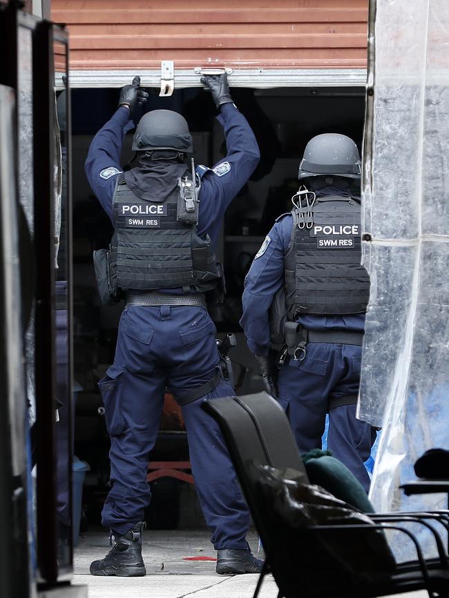 Officers search the premises during the raid.