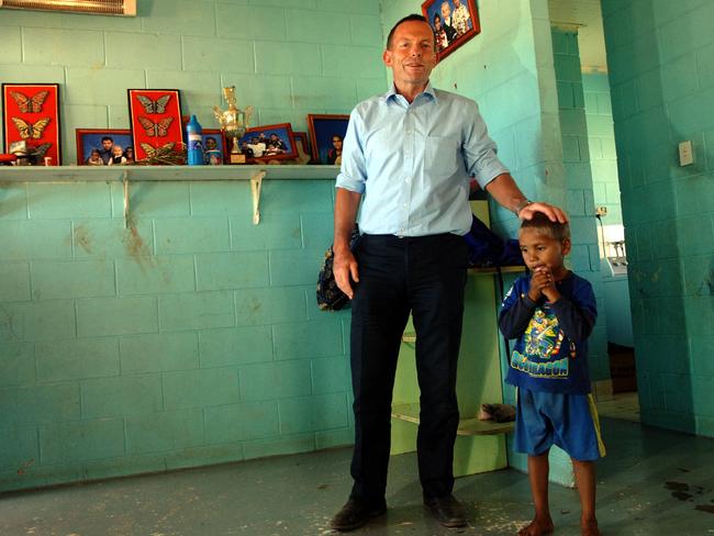 As federal opposition leader Mr Abbott visited Santa Teresa Aboriginal community 100km from Alice Springs to look at housing conditions.