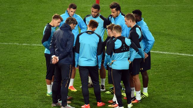 Tottenham Hotspur players listen to instructions.