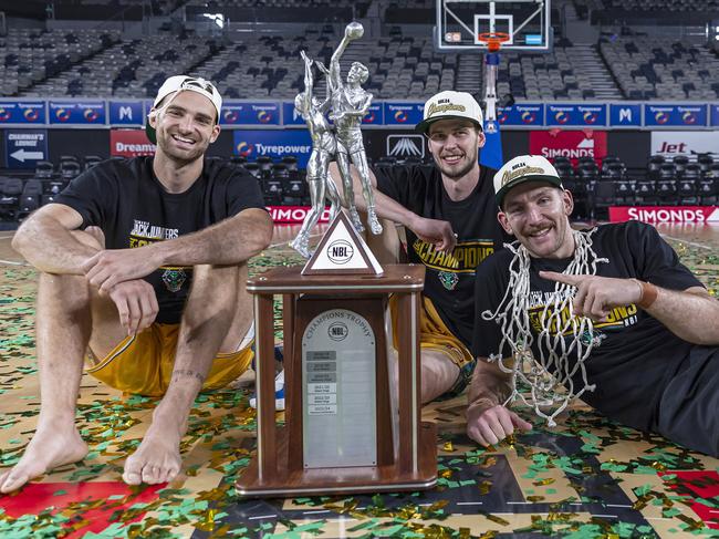 MELBOURNE, AUSTRALIA - MARCH 31: Jack McVeigh, Clint Steindl and Will Magnay of the JackJumpers celebrate with the trophy after winning game five of the NBL Championship Grand Final Series between Melbourne United and Tasmania JackJumpers at John Cain Arena, on March 31, 2024, in Melbourne, Australia. (Photo by Daniel Pockett/Getty Images)