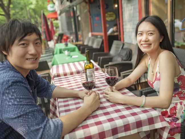 Mr. Liang Haochen and Ms. Qiu JiaYing toasting Labour Day with Penfolds Rawson's Retreat an Australian wine, whose sales grew 65% in the first quarter of this year to $A200 million, at Berry Bar in the Sanlitun neighborhood of Beijing, China, May 1, 2016. Pic Shannon Fagan