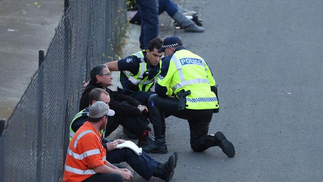 Police speak to someone at the scene of the crash. Picture: David Crosling