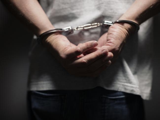 Arrested man in handcuffs with handcuffed hands behind back Picture: Istock