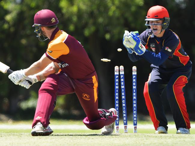 Tim Evans ofTea Tree Gully keeps his foot in the crease as Adelaide keeper Alex Eckland takes off the bails during theTwenty20 grade cricket match Adelaide v Tea Tree Gully at Glandore Oval,Saturday January 5,2019.(Image AAP/Mark Brake)