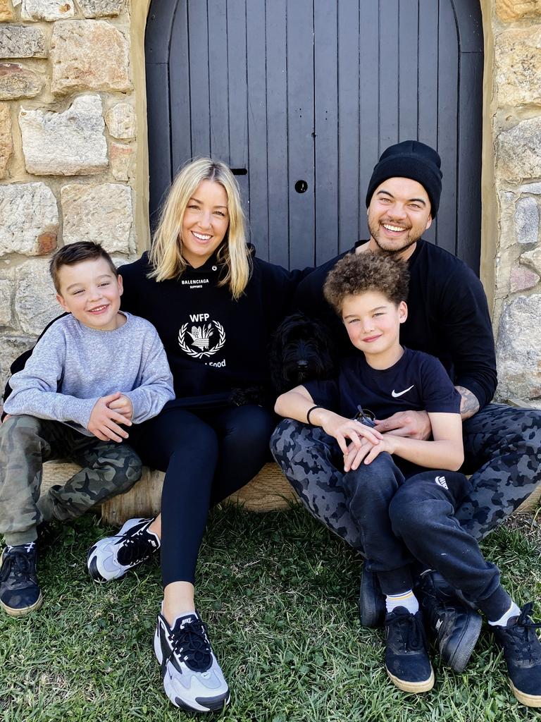 Jules and Guy with their sons Archer and Hudson, who are now aged 10 and eight.