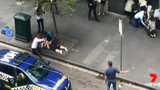 Henry Dow and Lou helping a victim during the Bourke Street tragedy in Melbourne. Picture: Channel 7