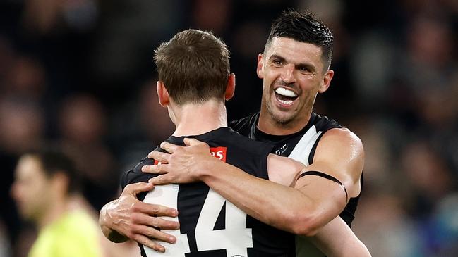 MELBOURNE, AUSTRALIA - AUGUST 17: Ned Long (left) and Scott Pendlebury of the Magpies celebrate during the 2024 AFL Round 23 match between the Collingwood Magpies and the Brisbane Lions at The Melbourne Cricket Ground on August 17, 2024 in Melbourne, Australia. (Photo by Michael Willson/AFL Photos via Getty Images)