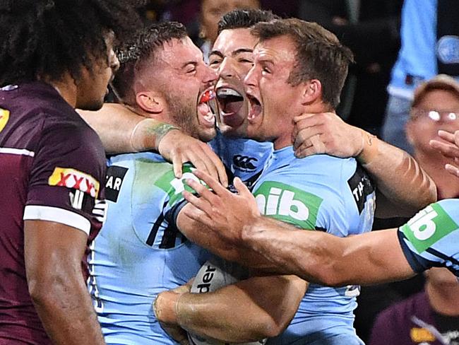 Josh Morris (right) celebrates his try with teammates James Tedesco (left) and Nick Cotric. Picture: AAP