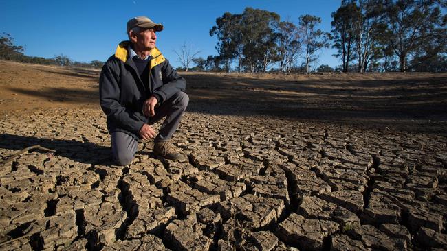 Drought conditions are affecting farmers in NSW. Cam Armstrong on a dried up dam on his sheep farm in Cassilis, NSW. Picture: Liam Driver.