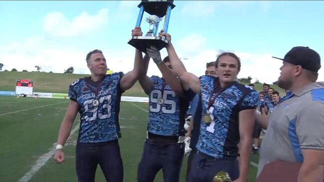 Gold Coast Stingrays Colts team captains raise the Sun Bowl trophy. Picture: Gridiron Queensland