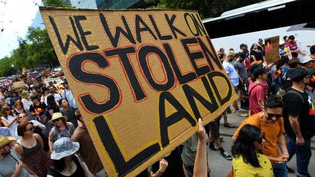 Protesters are seen during an Invasion Day rally.