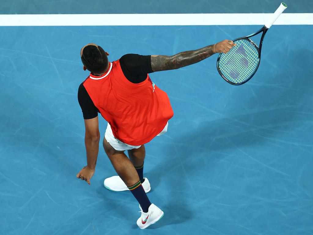 Nick Kyrgios smashes a ball into the crowd with his racquet handle after it ballooned back off the net cord from a serve attempt. Picture: Cameron Spencer/Getty Images